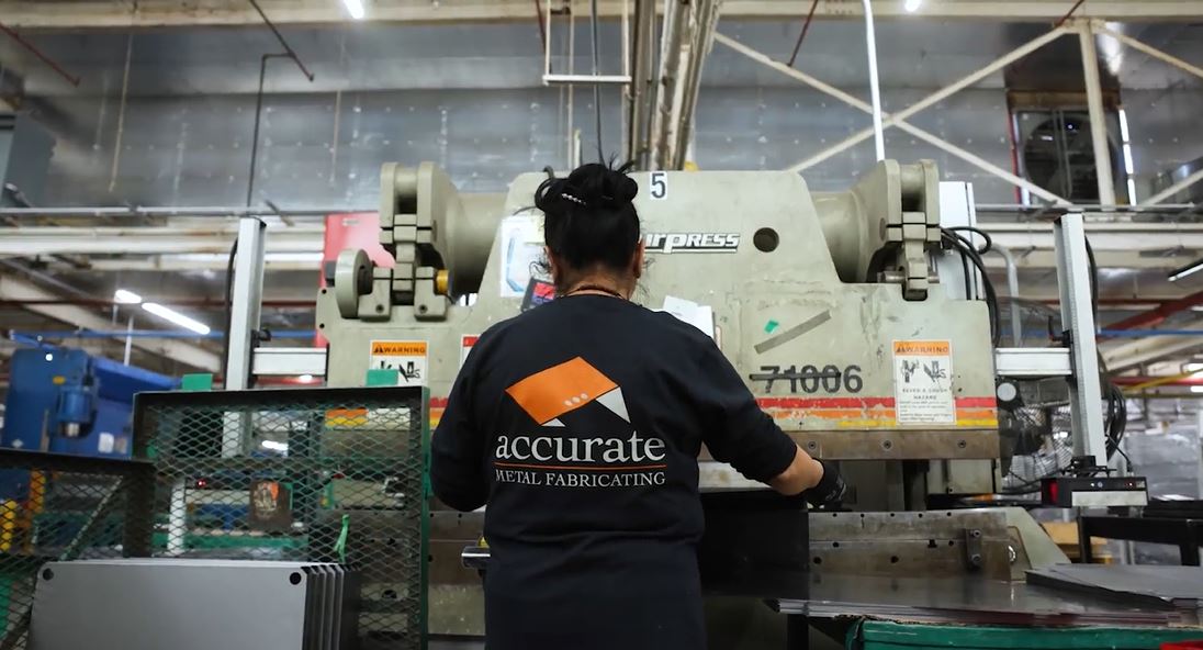 a woman forming metal with a press brake