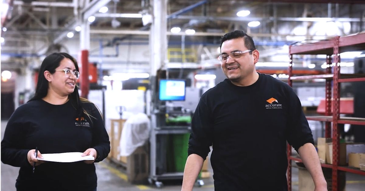 two project managers walking down an aisle